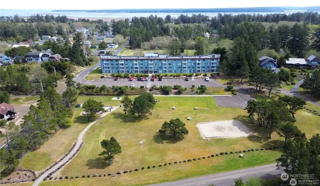 an aerial view of a house with a garden and lake view