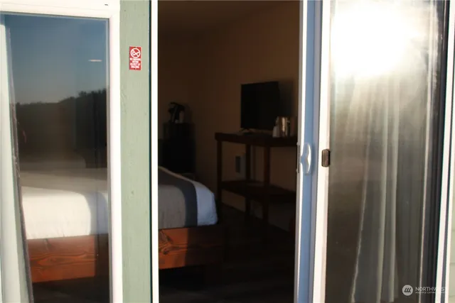 a bedroom with a bed and mirror