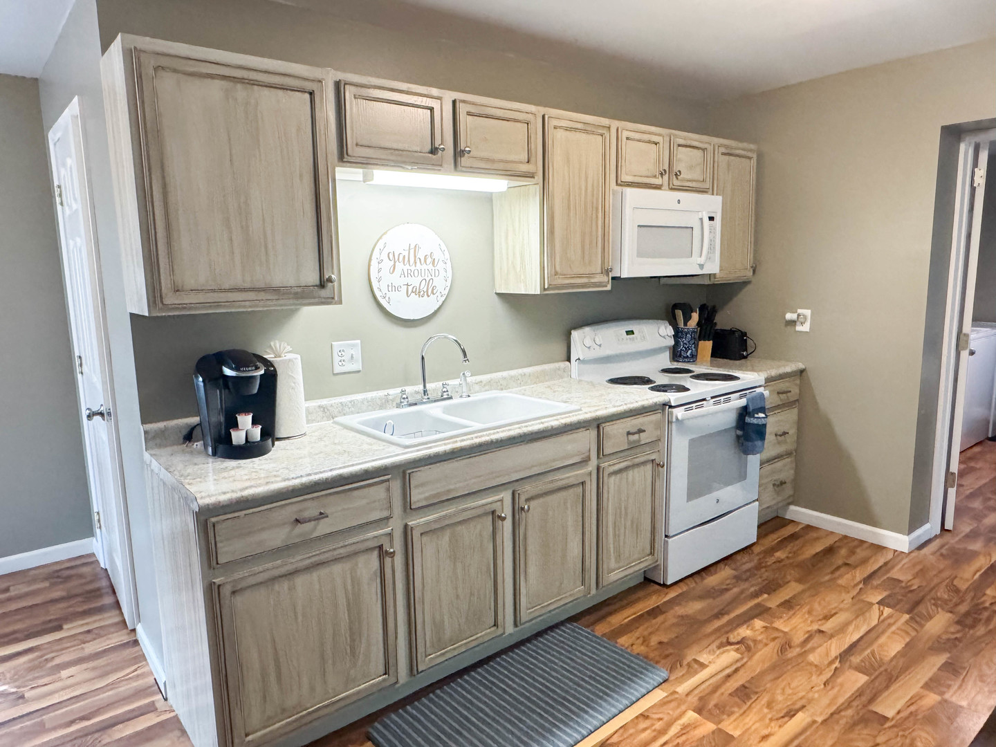 113 Lafayette Street Anna, IL 62906 - Photo 16 of 33 a kitchen with a sink cabinets and wooden floor