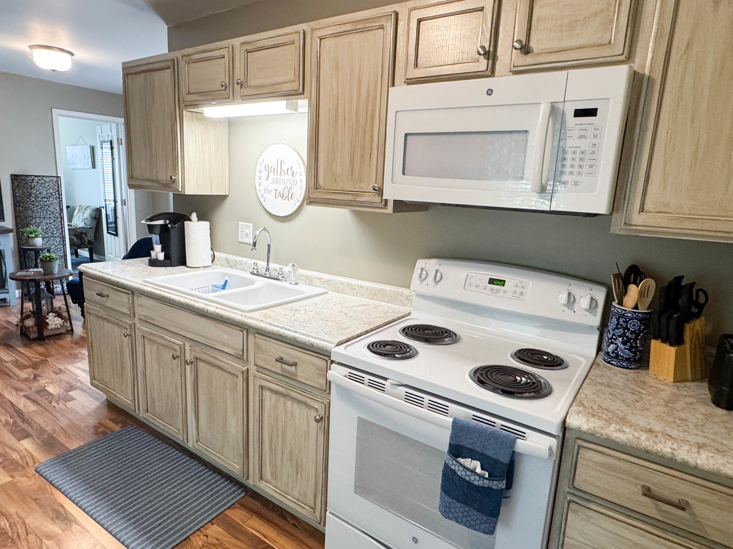 113 Lafayette Street Anna, IL 62906 - Photo 18 of 33 a kitchen with kitchen island a stove a sink and a refrigerator with white cabinets