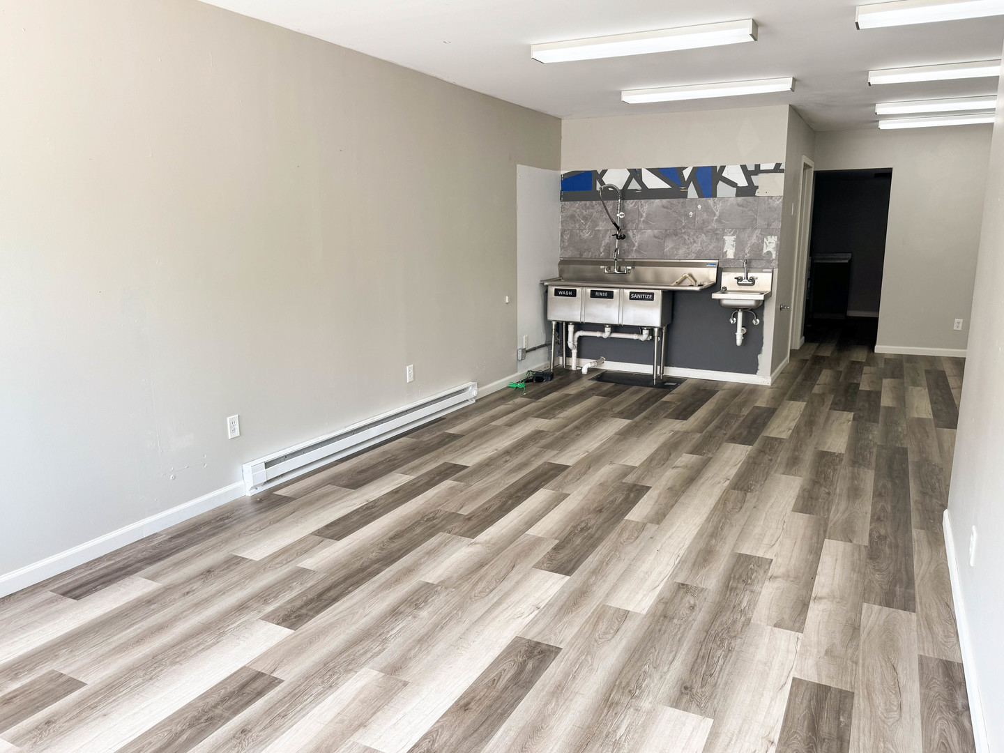 113 Lafayette Street Anna, IL 62906 - Photo 27 of 33 a view of a room with kitchen island stainless steel appliances wooden floor and view living room