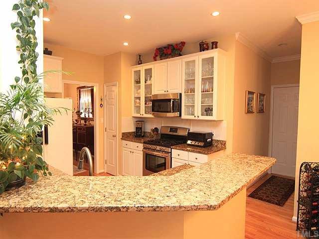 106 Sterling Ridge Way Cary, NC 27519 - Photo 4 of 12 Enjoy cooking and entertaining in this modern updated kitchen! Recessed Lighting,5 burner gas cook and granite counter tops.