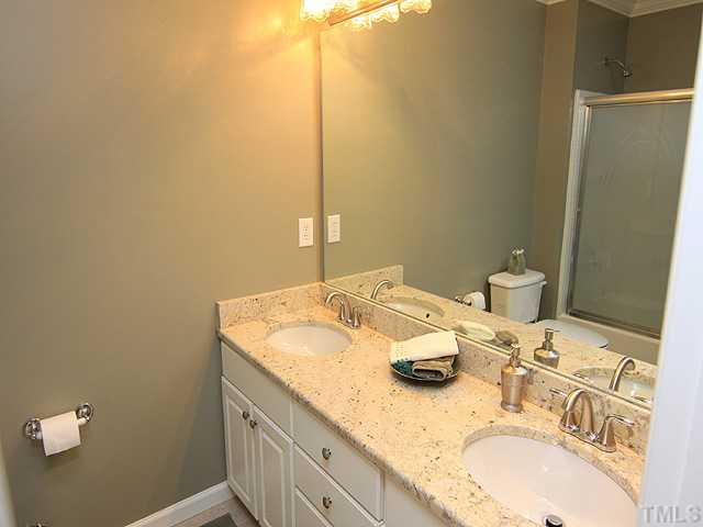 106 Sterling Ridge Way Cary, NC 27519 - Photo 5 of 12 Secondary bathroom with granite counter top, marble flooring and new brushed nickel faucets.