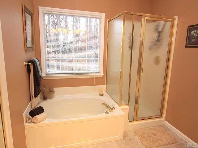 106 Sterling Ridge Way Cary, NC 27519 - Photo 8 of 12 Master Bath has double sinks,garden tub with marble floors and huge walk-in closet.