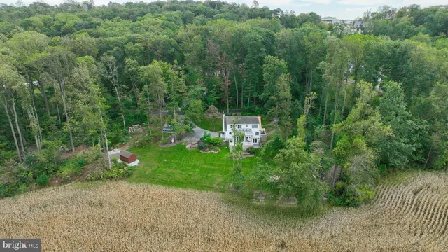 an aerial view of a house with a yard
