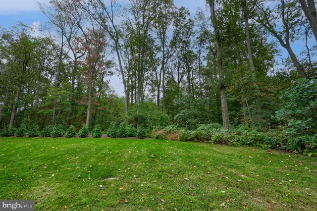 a view of a wooden chairs and table on the deck
