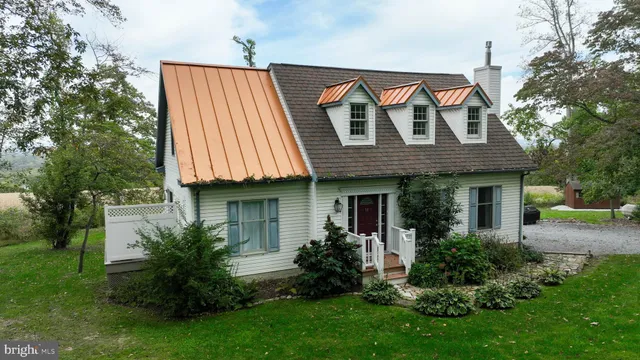 a front view of a house with a garden and plants