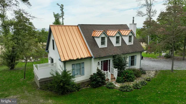a front view of a house with a yard and potted plants
