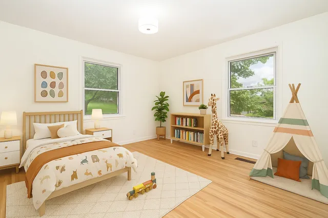 a bedroom with a bed a bookshelf and a window
