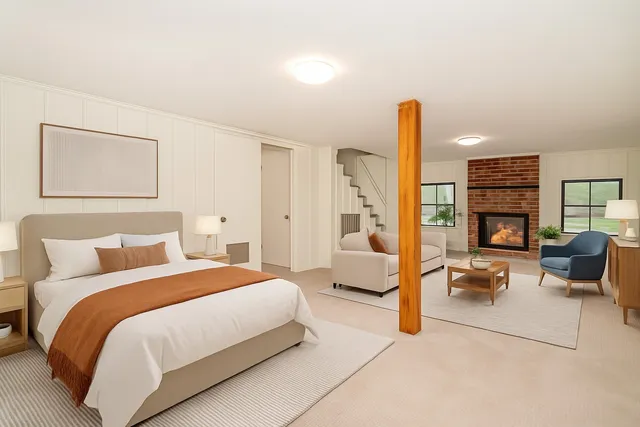 a bedroom with a bed couch and a book shelf