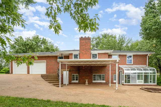 a view of a house with a garage and yard