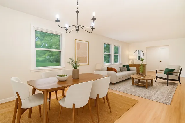 a living room with furniture a window and a table