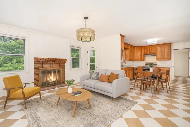 a living room with furniture chandelier and a fireplace