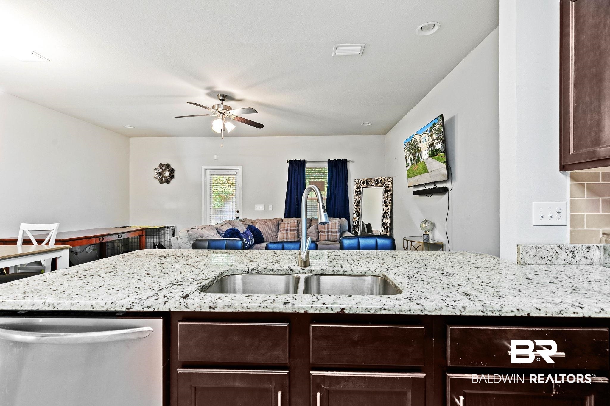 25806 Pollard Road, Unit 24 Daphne, AL 36526 - Photo 12 of 33 Kitchen featuring dark brown cabinets, light stone countertops, stainless steel dishwasher, a peninsula, and recessed lighting