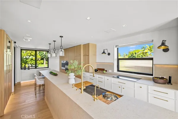 a large white kitchen with a large window