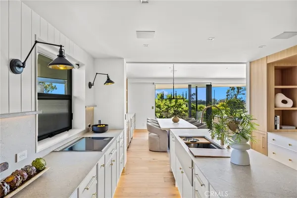 a kitchen with stainless steel appliances a stove a sink and a refrigerator