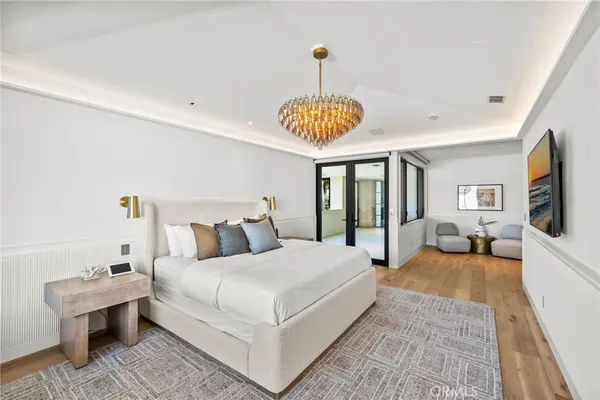 a bedroom with a bed couch and a view of kitchen