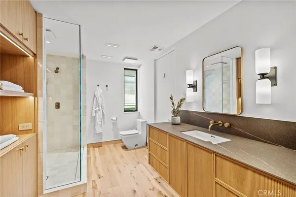 a spacious bathroom with a granite countertop sink and a mirror