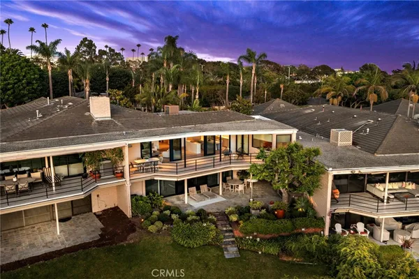 a view of a house with swimming pool next to a yard