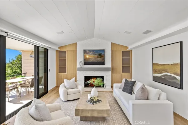 a living room with furniture fireplace and a large window