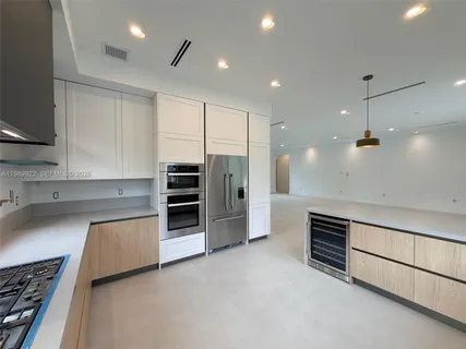 a kitchen with a cabinets and window