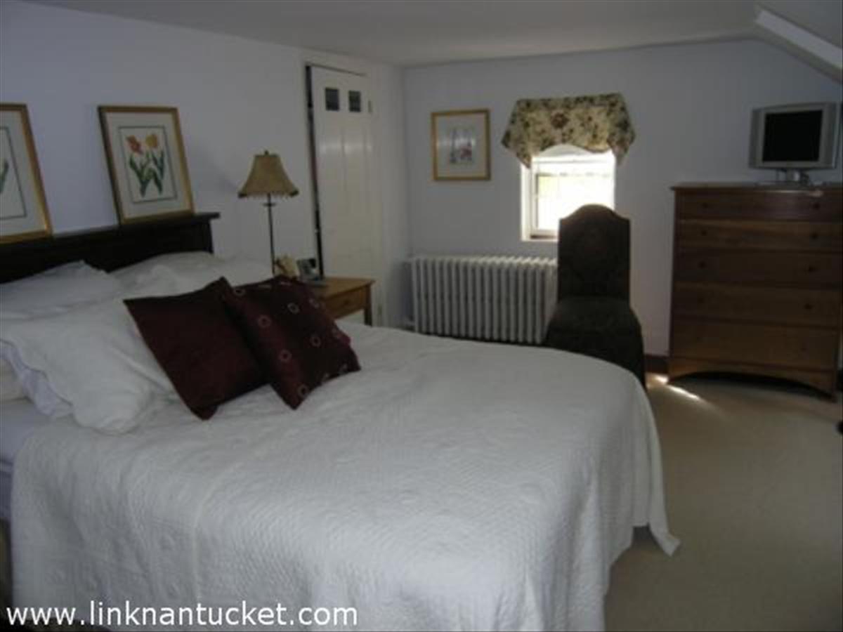 16 Vestal Street Nantucket, MA 02554 - Photo 9 of 10 a bedroom with a bed window and dresser