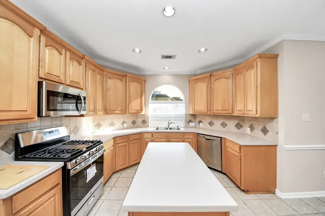 a kitchen with a stove a sink and a refrigerator