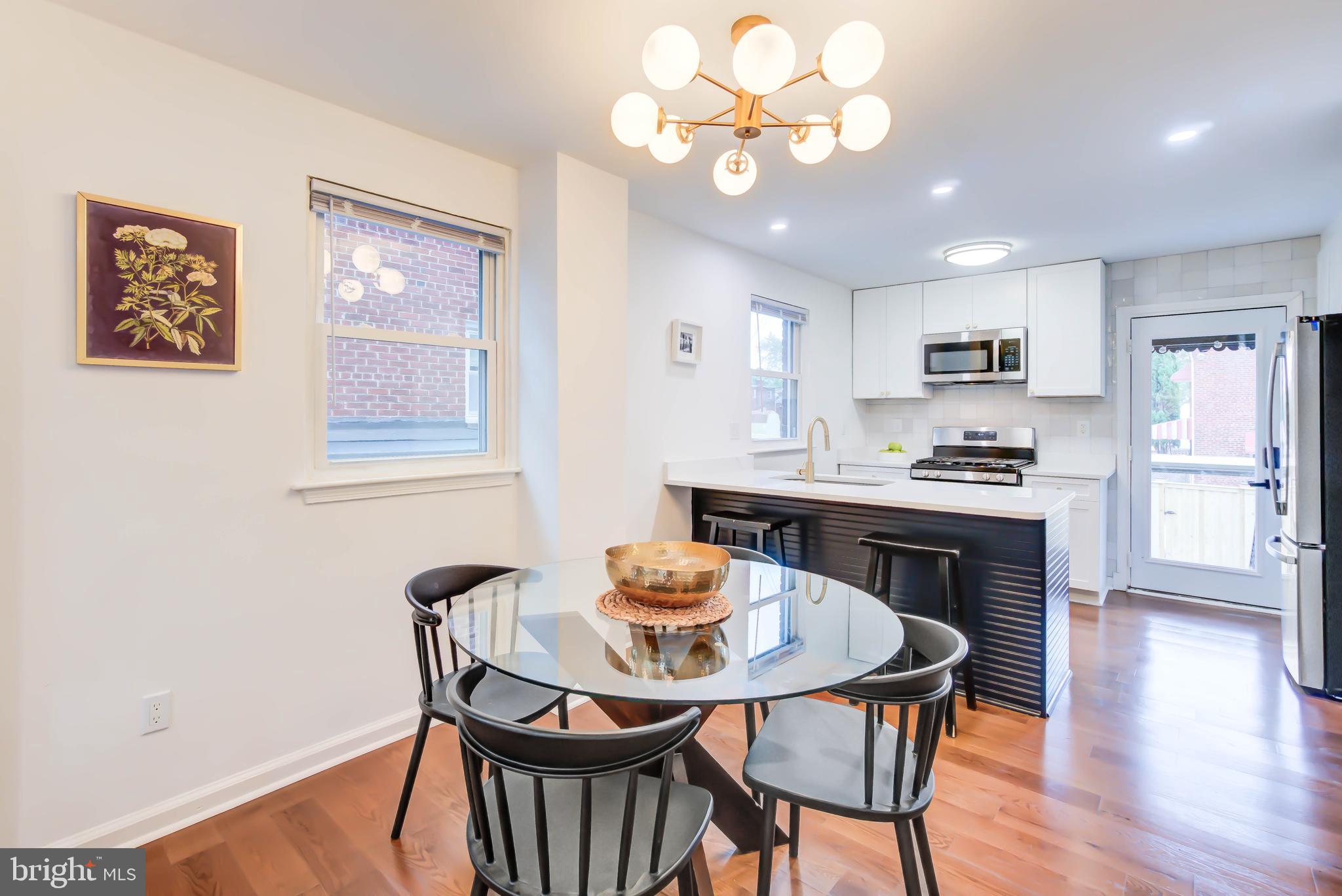 459 Riggs Road Northeast Washington, DC 20011 - Photo 15 of 57 a view of a dining room with furniture a chandelier and wooden floor