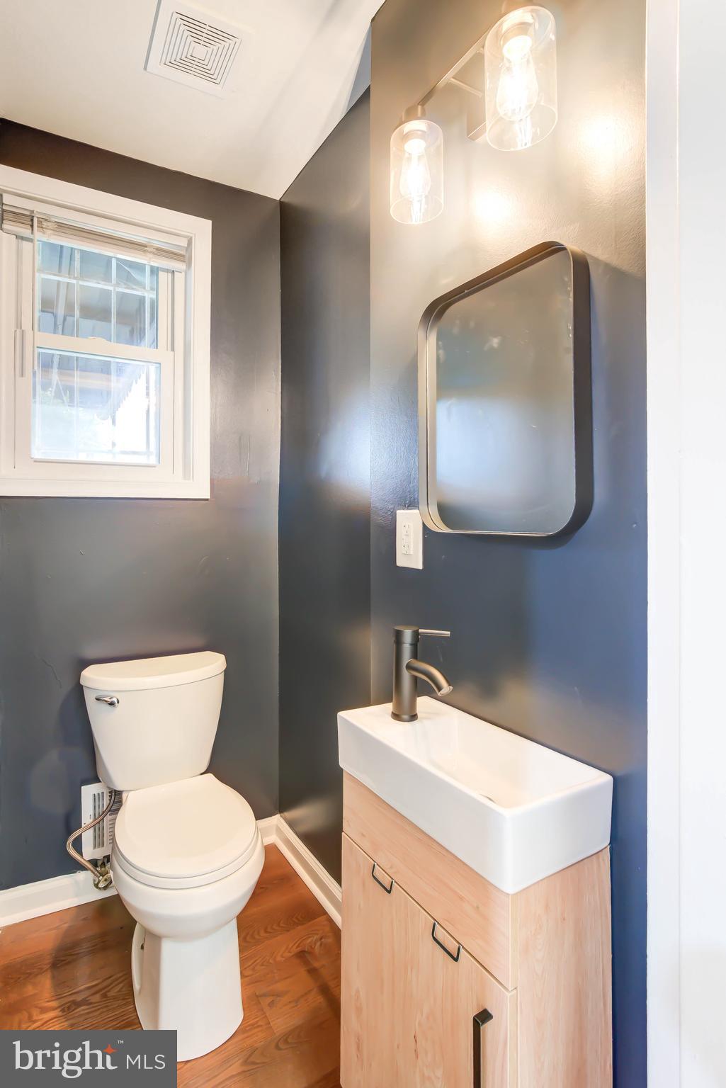 459 Riggs Road Northeast Washington, DC 20011 - Photo 27 of 57 a bathroom with a toilet a sink and mirror