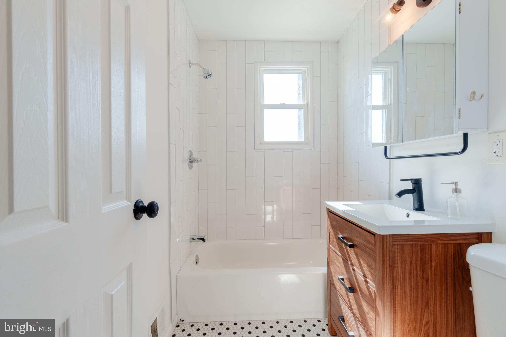 459 Riggs Road Northeast Washington, DC 20011 - Photo 35 of 57 a bathroom with a sink a toilet and shower