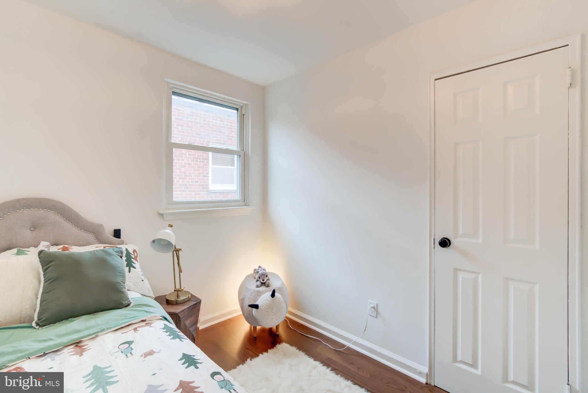 459 Riggs Road Northeast Washington, DC 20011 - Photo 36 of 57 a bedroom with a bed and wooden floor