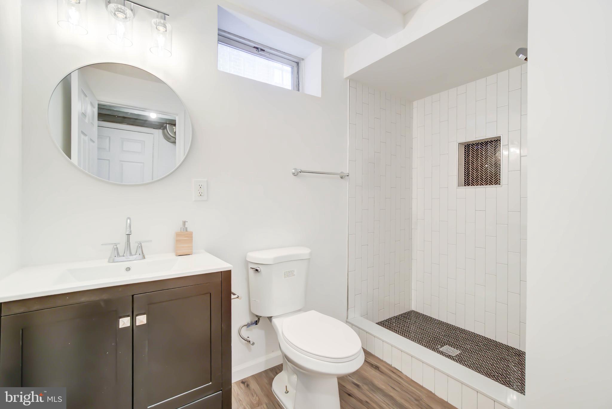 459 Riggs Road Northeast Washington, DC 20011 - Photo 40 of 57 a bathroom with a toilet a sink and mirror