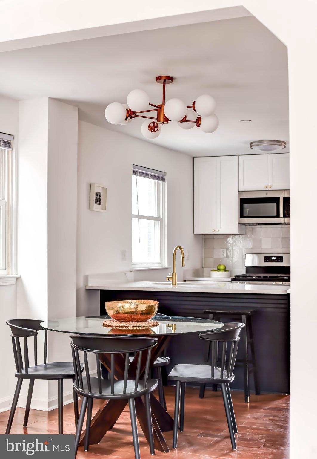 459 Riggs Road Northeast Washington, DC 20011 - Photo 4 of 57 a dining room with a wooden table and chairs
