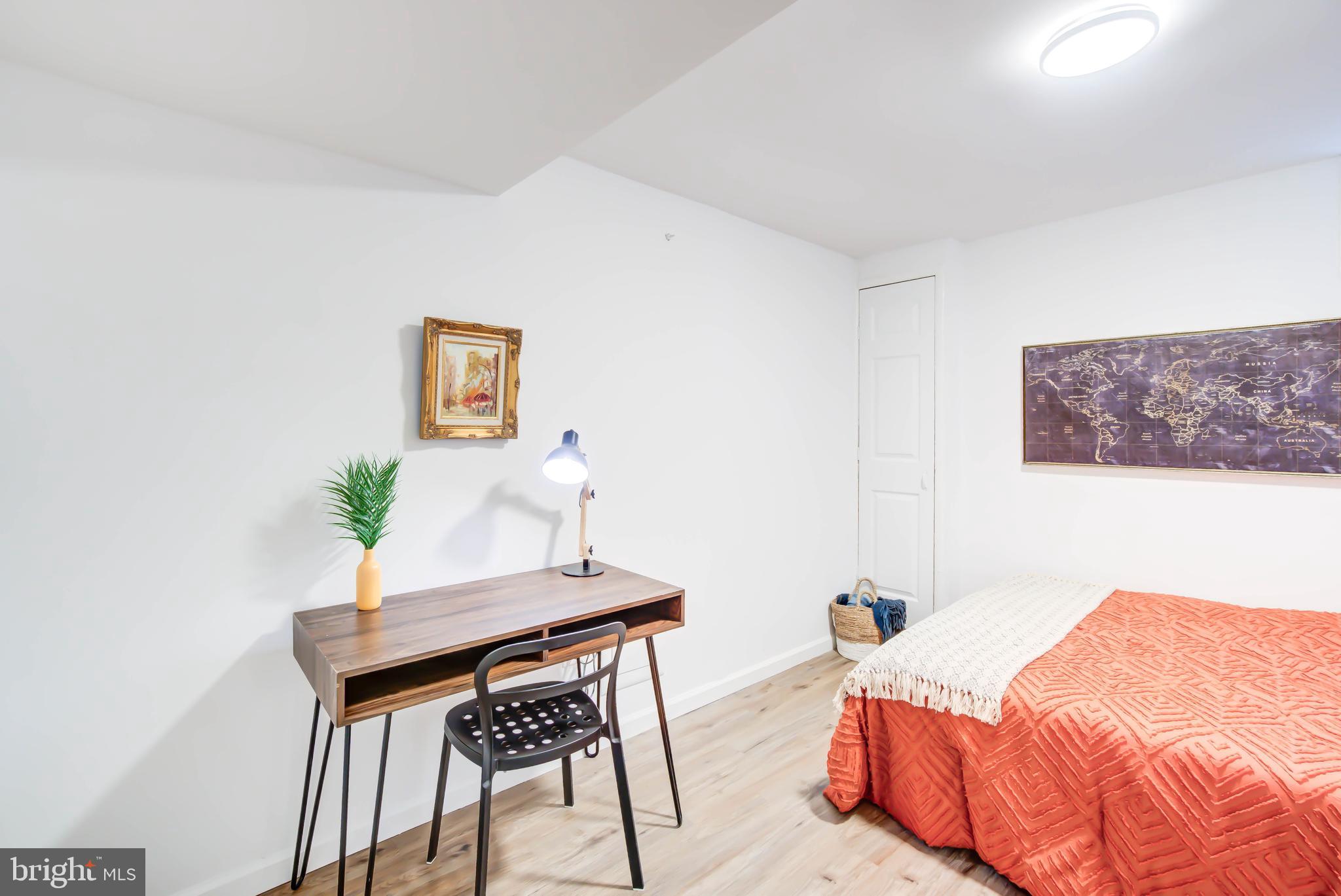 459 Riggs Road Northeast Washington, DC 20011 - Photo 43 of 57 a bedroom with a bed and a table in it