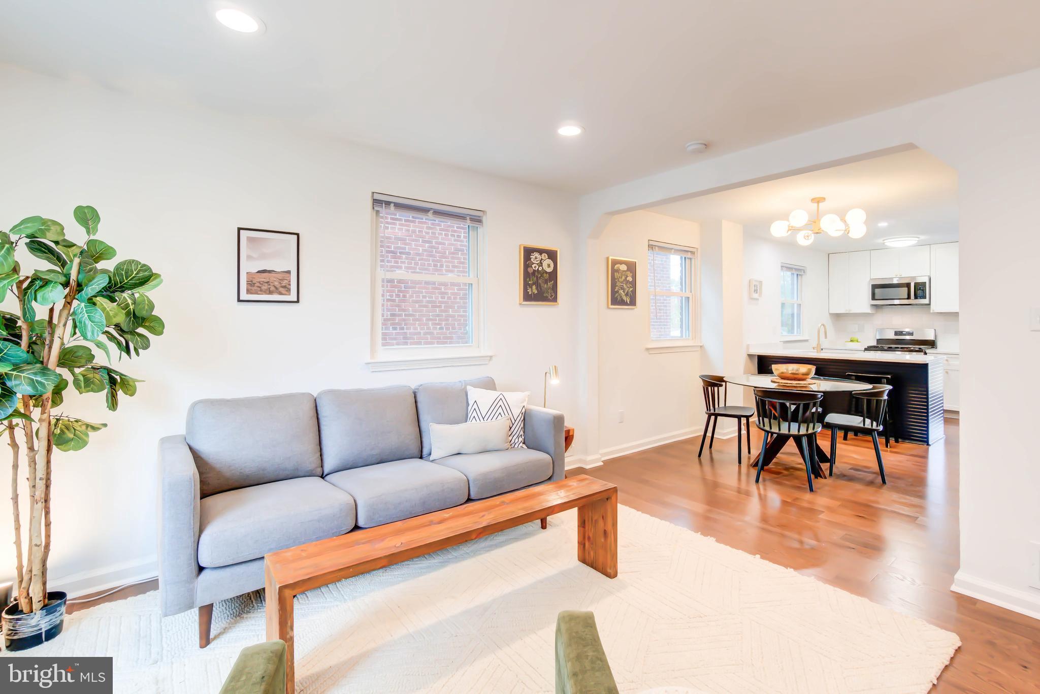 459 Riggs Road Northeast Washington, DC 20011 - Photo 10 of 57 a living room with furniture and a dining table with wooden floor