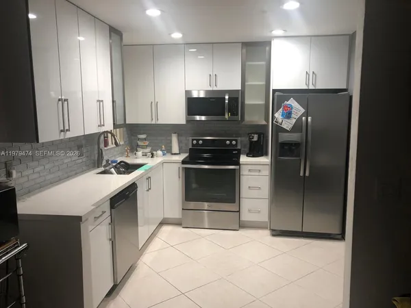a kitchen with a sink cabinets and stainless steel appliances