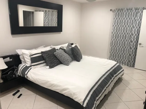 a bedroom with a bed and a mirror