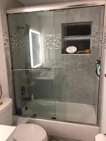 a bathroom with a shower and mirror