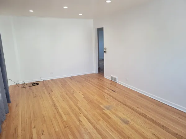 an empty room with wooden floor