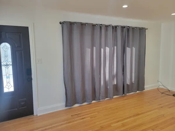 a view of balcony with wooden floor
