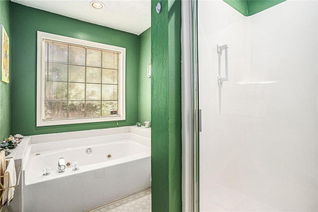 45 Saratoga Way Covington, GA 30016 - Photo 24 of 29 a bathroom with a bathtub and a window