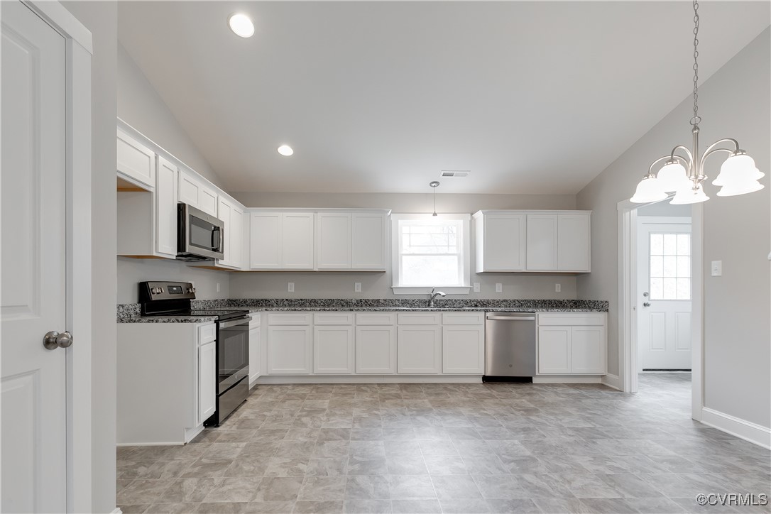 68 Halls Store Road Mineral, VA 23117 - Photo 7 of 30 a kitchen with stainless steel appliances granite countertop a stove top oven a sink a refrigerator and white cabinets