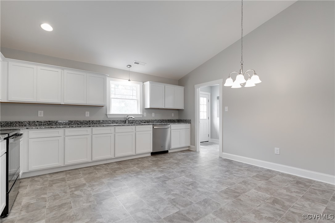 68 Halls Store Road Mineral, VA 23117 - Photo 9 of 30 a large kitchen with granite countertop a stove a sink a window and white cabinets
