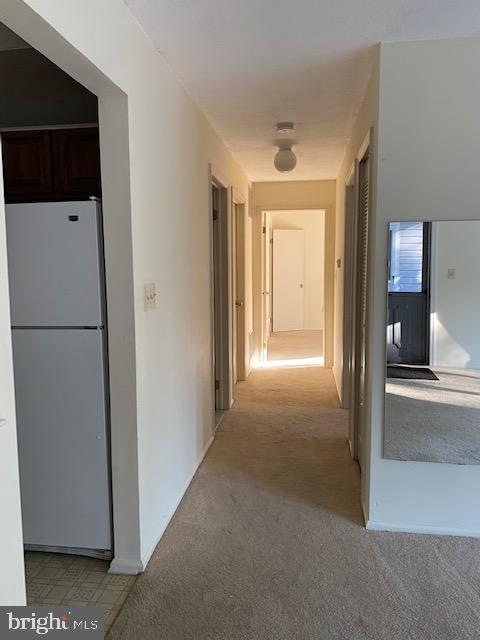 39 Mulberry Court Hamilton, NJ 08619 - Photo 11 of 24 a view of a hallway with a refrigerator and a table