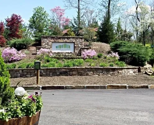 a view of a house with a yard and a bench