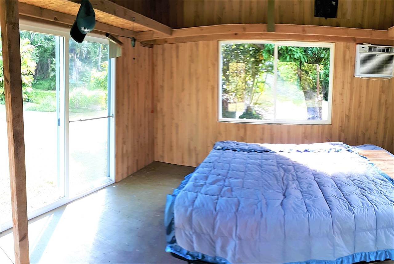 350 Hoolawa Road Haiku, HI 96708 - Photo 14 of 23 a bed sitting in a bedroom next to a window