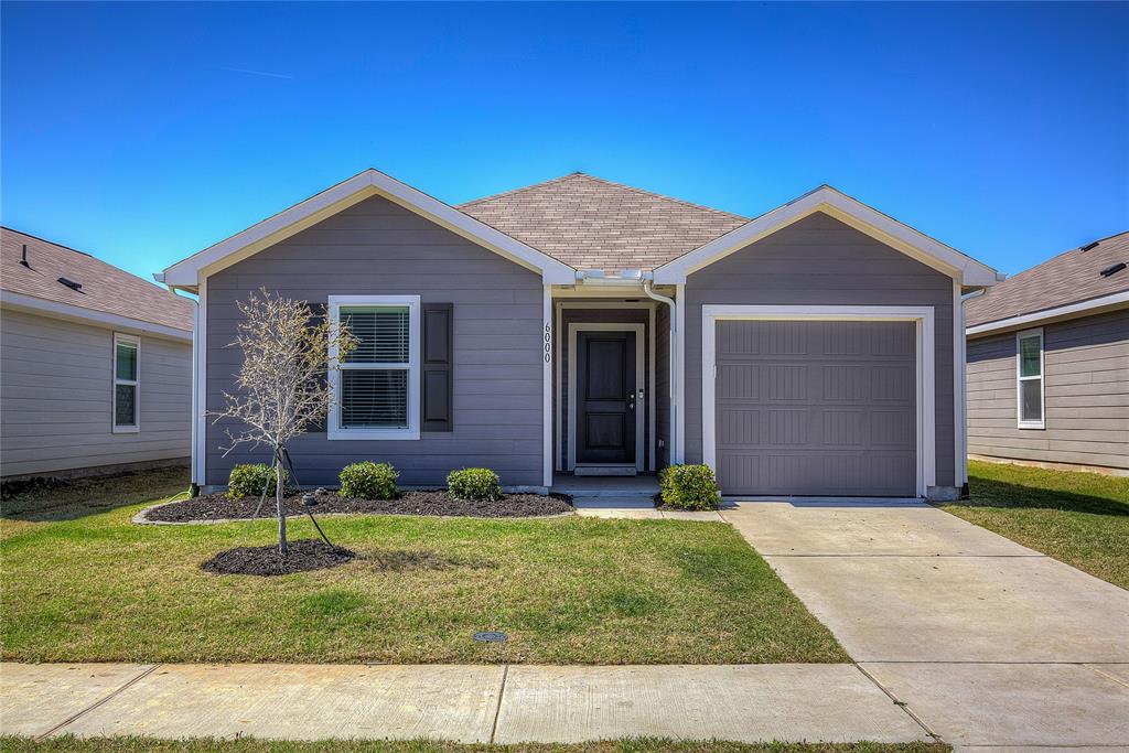 Front Exterior –Charming single-story home with clean landscaping, covered entry, and attached 1-car garage.