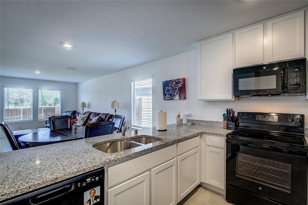 6000 Sumlin Way Princeton, TX 75407 - Photo 12 of 36 Kitchen View– Large island with breakfast bar overlooking living and dining areas.