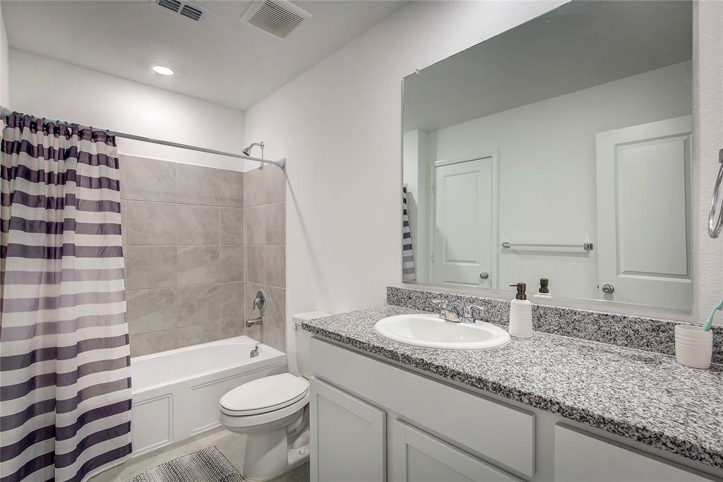 6000 Sumlin Way Princeton, TX 75407 - Photo 25 of 36 Primary bathroom featuring a vanity, shower/tub combo, and ample cabinet and storage space.