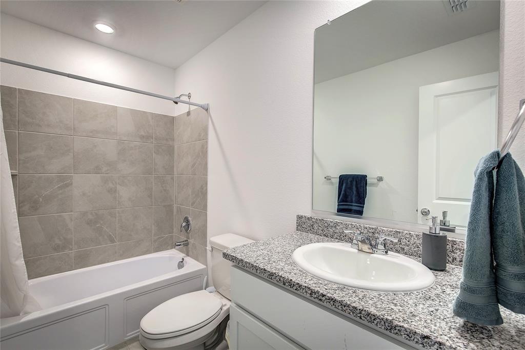 6000 Sumlin Way Princeton, TX 75407 - Photo 29 of 36 Clean full bathroom with granite countertop and tiled shower/tub combo.